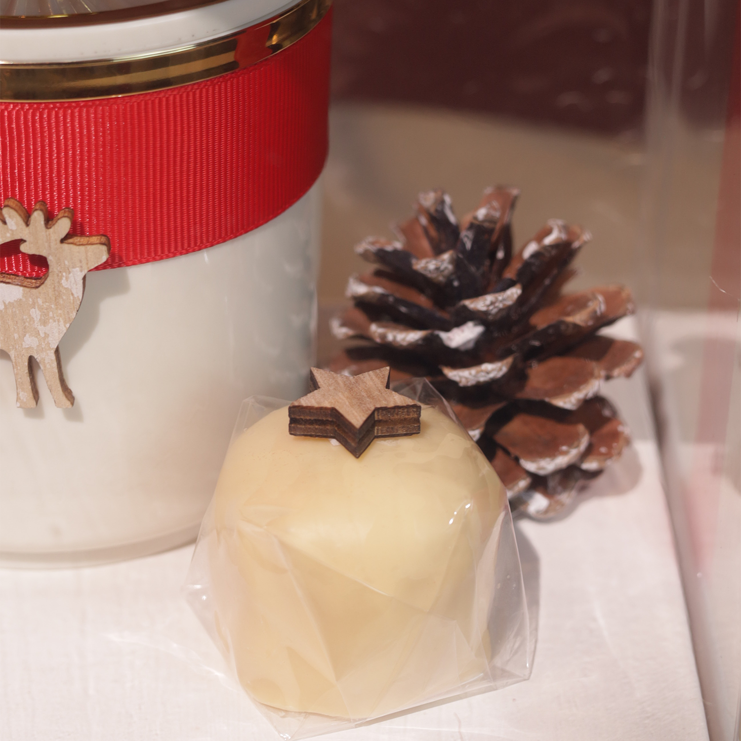 White box with beige jar